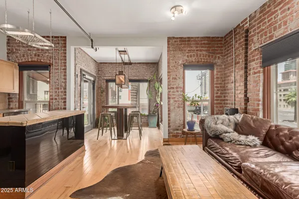 a bedroom with furniture and a large window