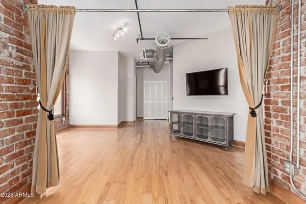 a view of a livingroom with furniture and flat screen tv
