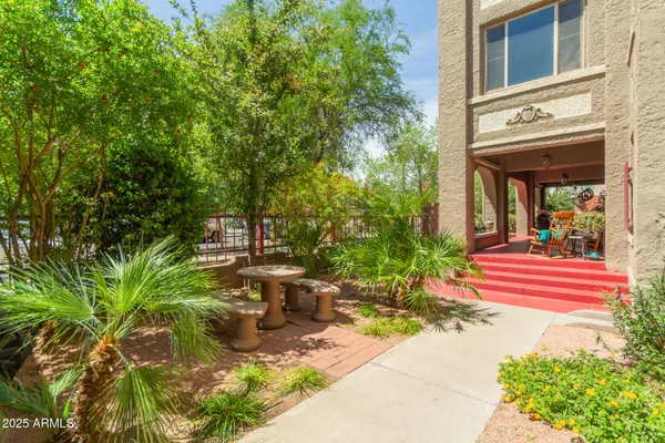 a view of a building with garden and sitting area