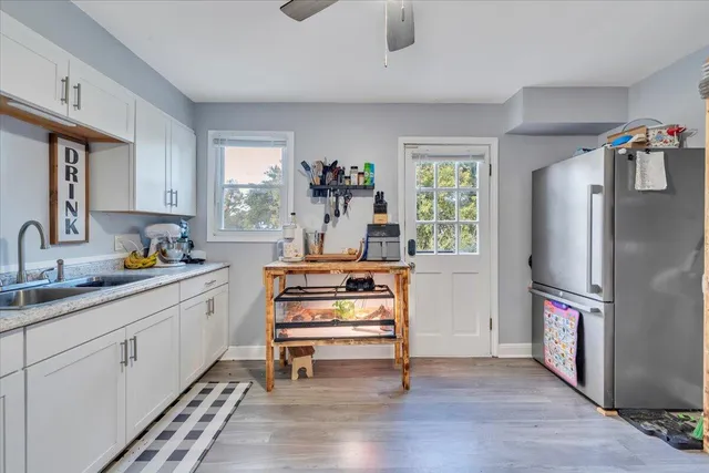 a kitchen with a refrigerator and a sink