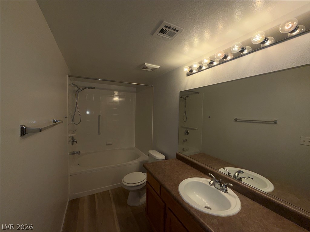 7255 West Sunset Road, Unit 1158 Las Vegas, NV 89113 - Photo 7 of 10 A well-lit primary bathroom featuring a combined shower and tub, with a spacious vanity and reflective mirror.