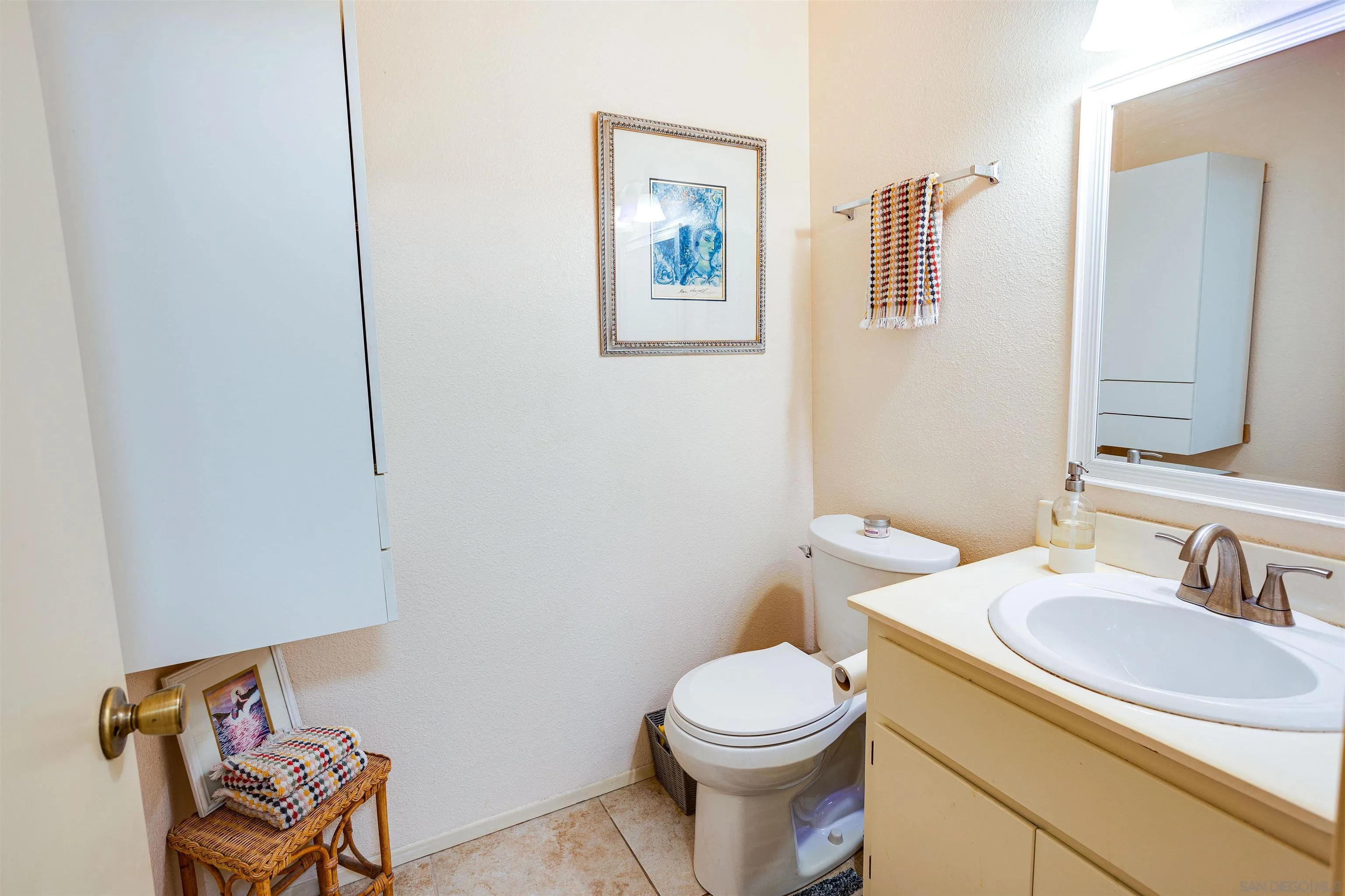 13657 Comuna Drive Poway, CA 92064 - Photo 11 of 36 a bathroom with a toilet a sink and mirror
