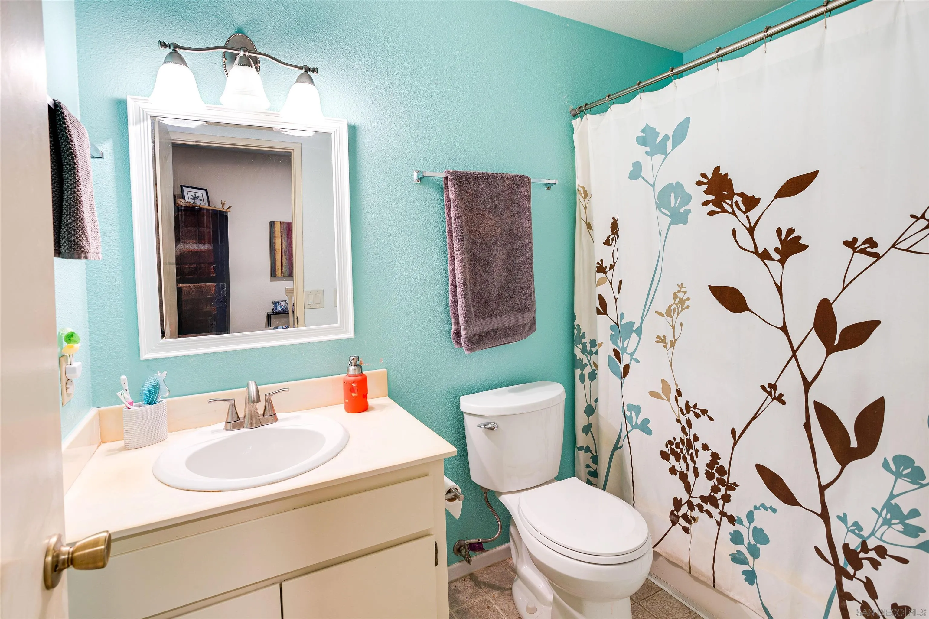 13657 Comuna Drive Poway, CA 92064 - Photo 15 of 36 a bathroom with a toilet sink and mirror