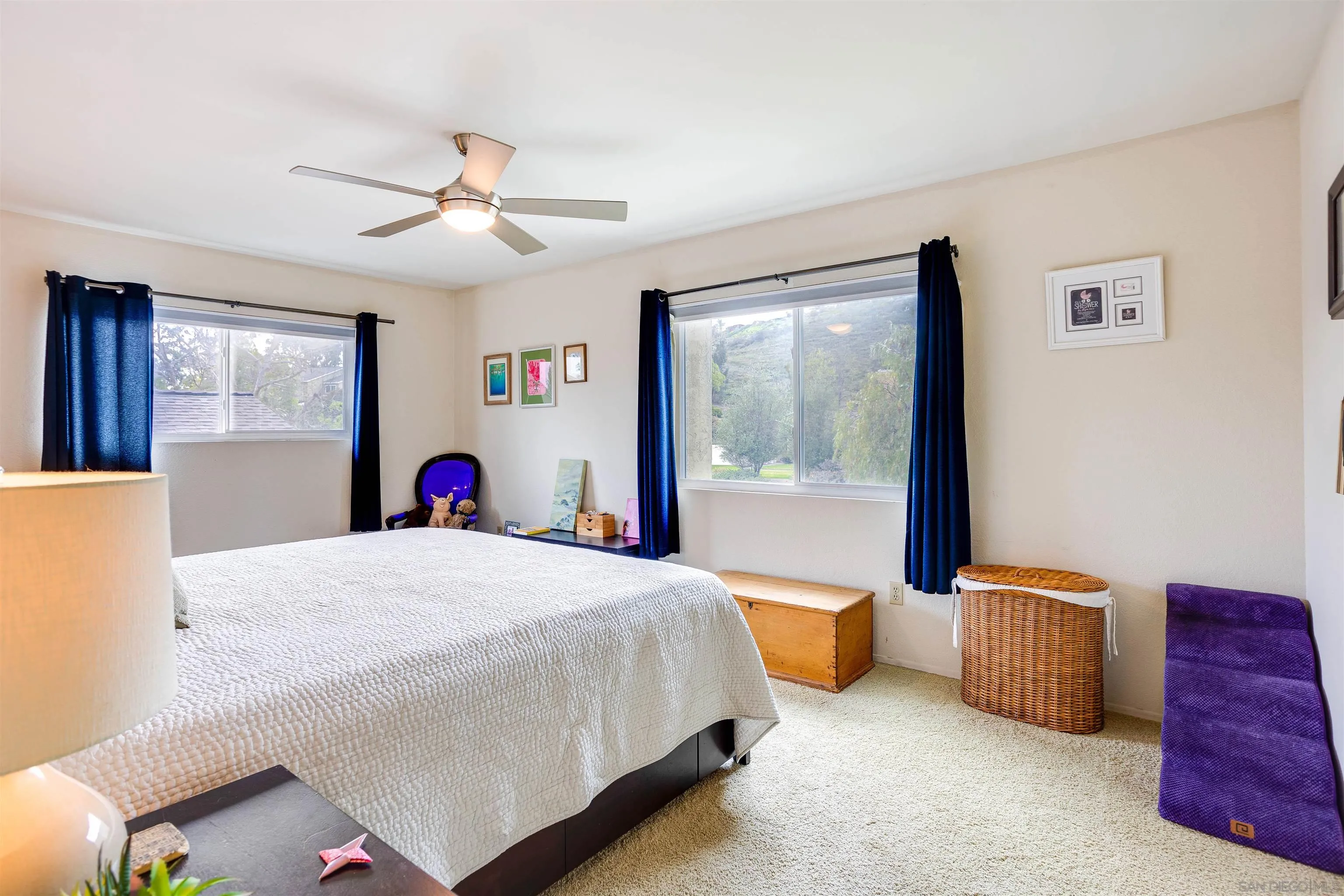 13657 Comuna Drive Poway, CA 92064 - Photo 16 of 36 a bedroom with a bed and a chandelier