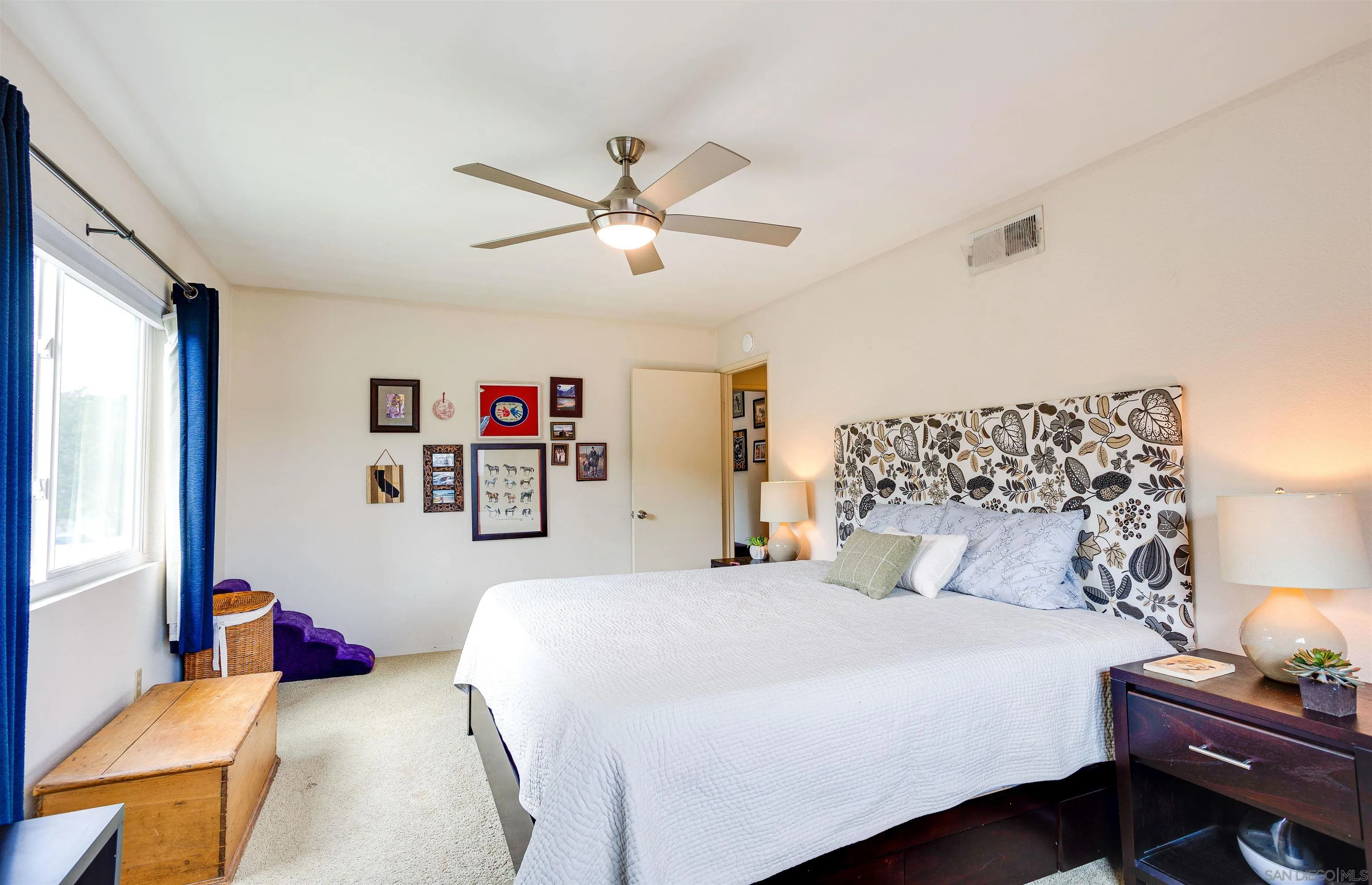 13657 Comuna Drive Poway, CA 92064 - Photo 17 of 36 a bedroom with a bed and a chandelier