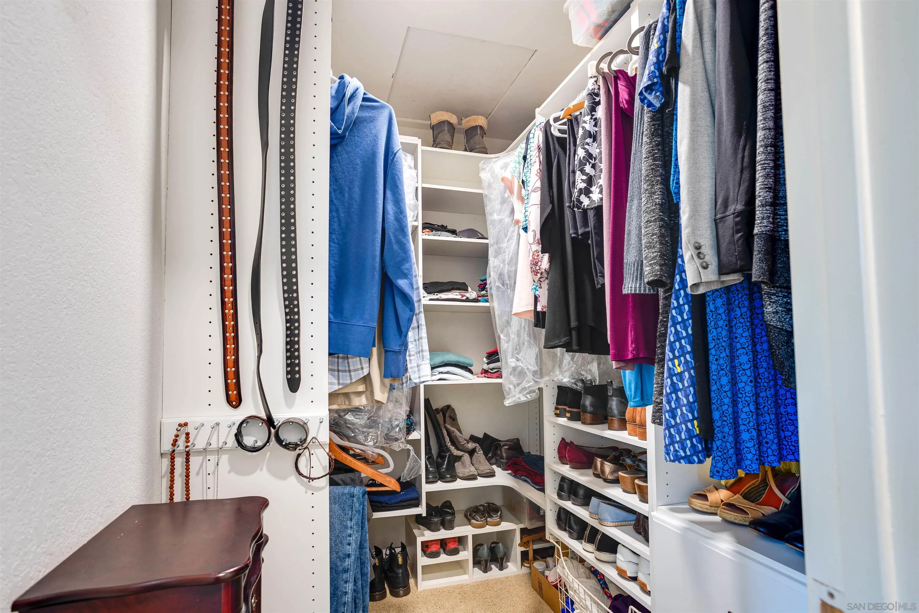 13657 Comuna Drive Poway, CA 92064 - Photo 18 of 36 a view of walk in closet with clothes and shoes
