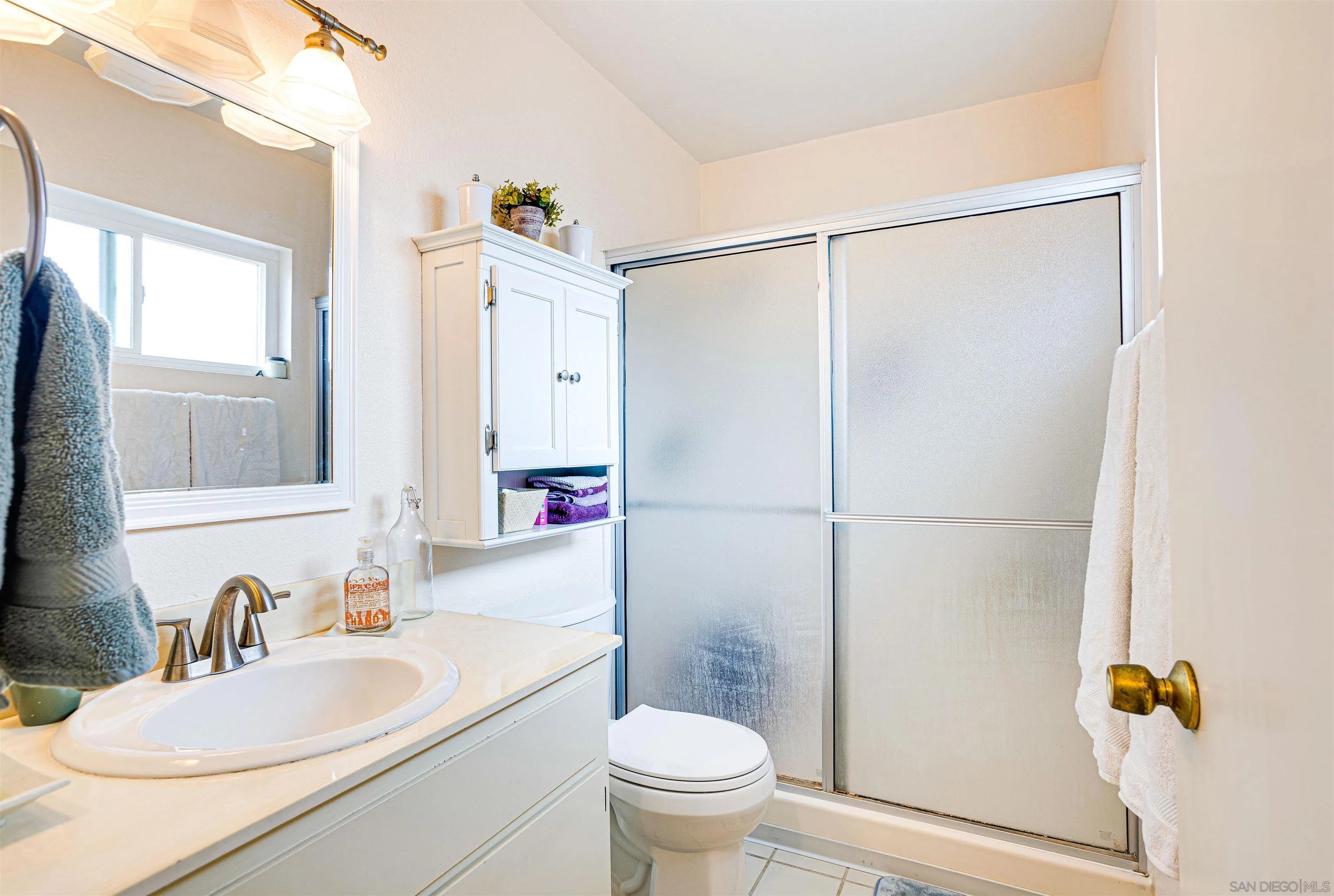 13657 Comuna Drive Poway, CA 92064 - Photo 19 of 36 a bathroom with a granite countertop sink toilet and shower