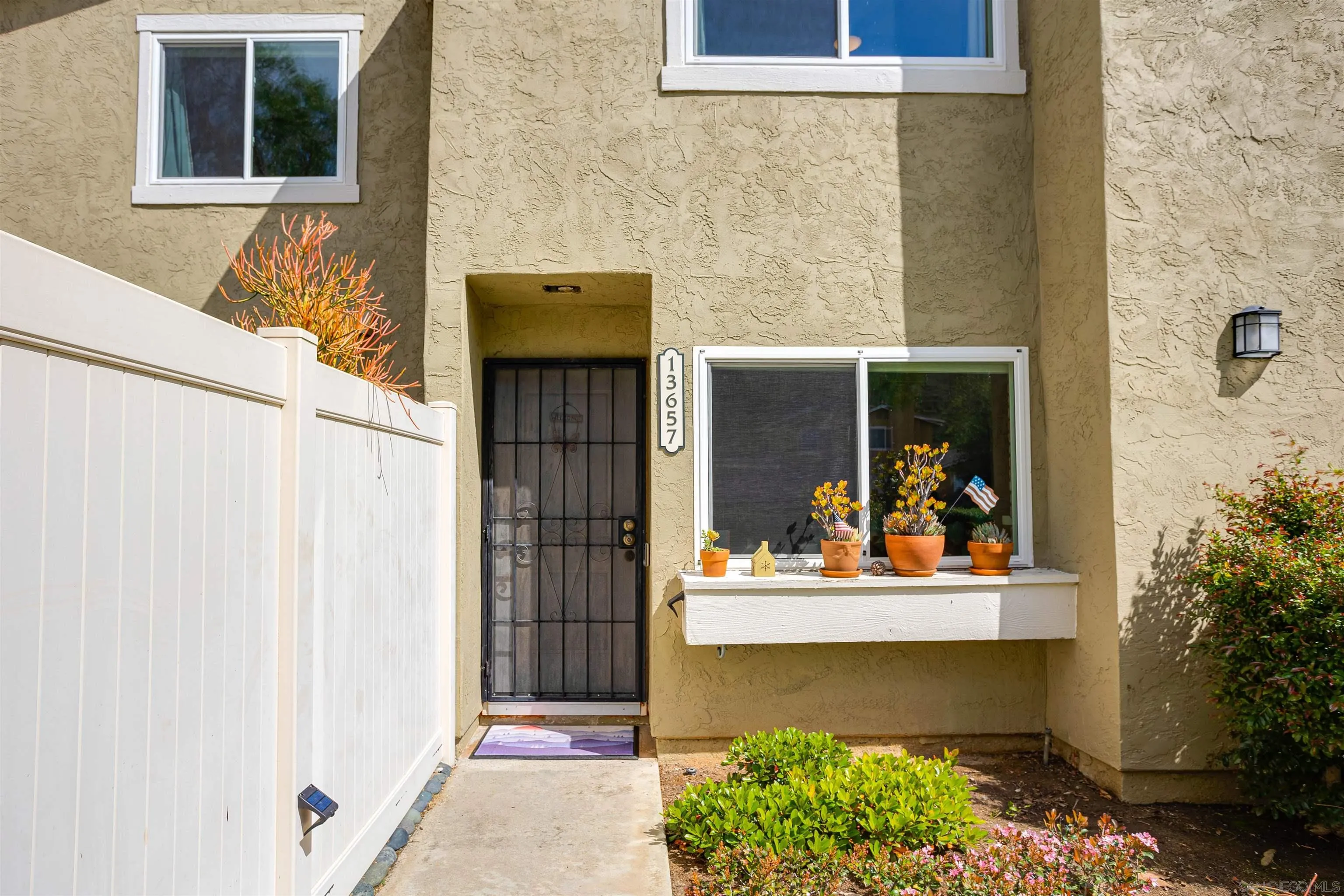 13657 Comuna Drive Poway, CA 92064 - Photo 28 of 36 a front view of a house with a yard