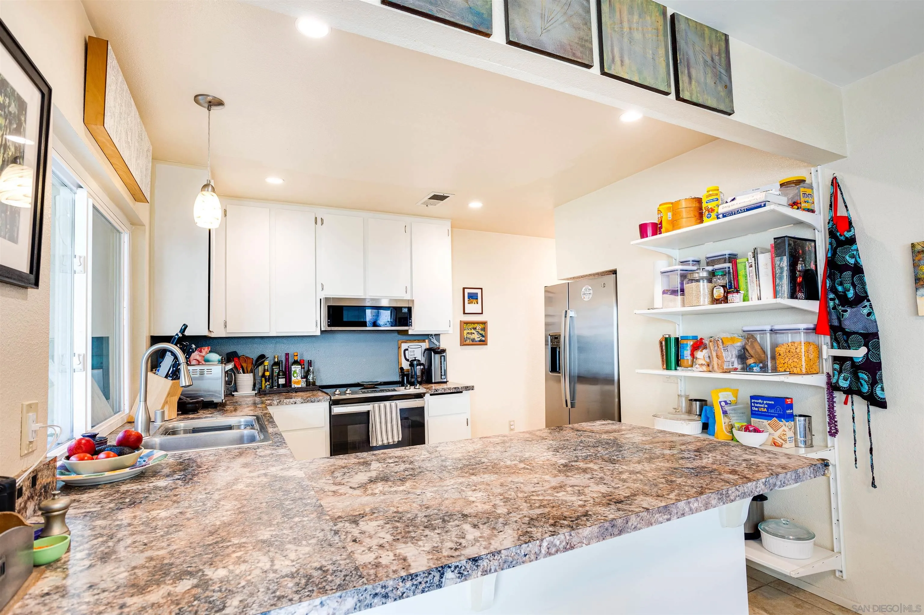 13657 Comuna Drive Poway, CA 92064 - Photo 5 of 36 a kitchen with stainless steel appliances granite countertop a sink refrigerator and microwave