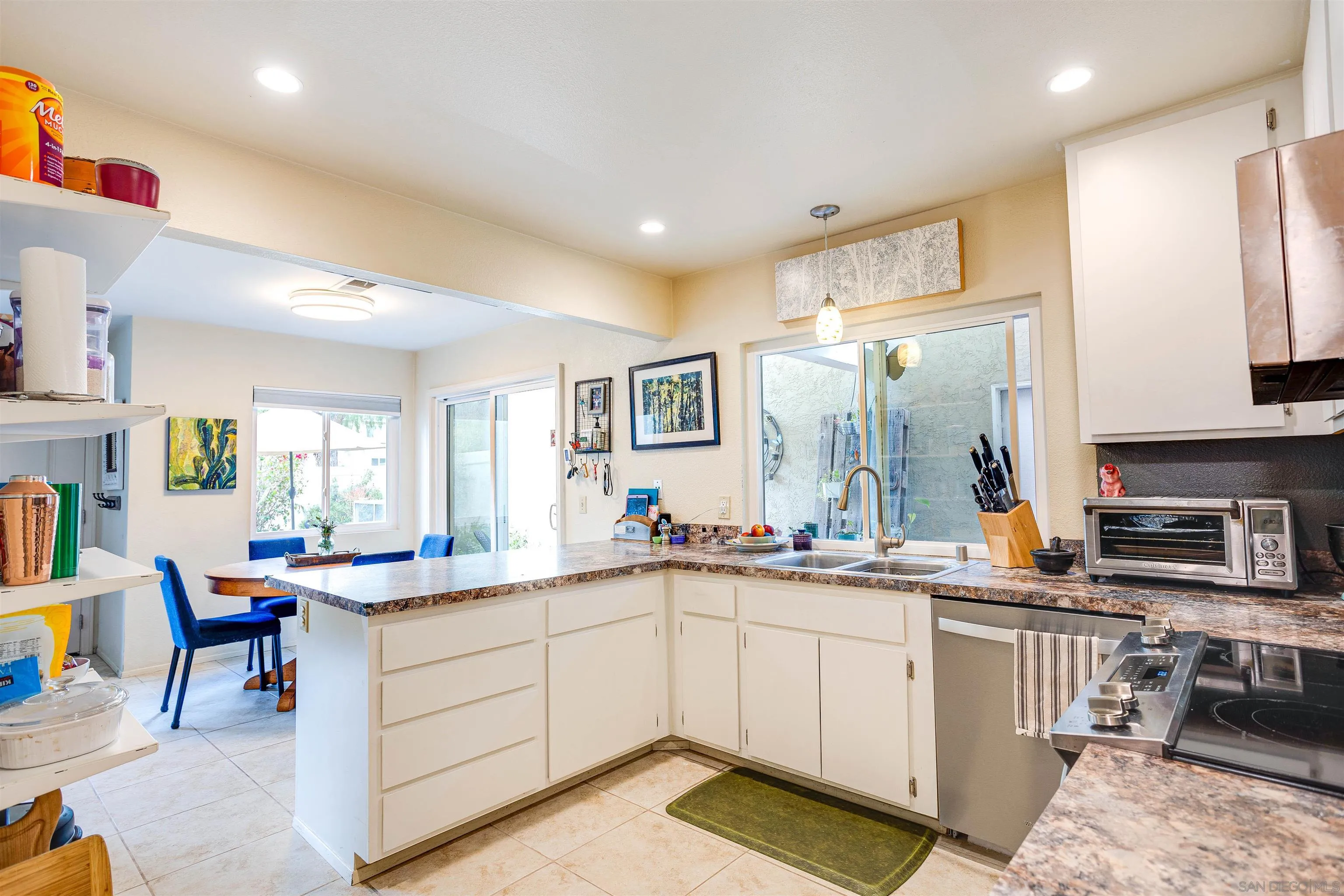 13657 Comuna Drive Poway, CA 92064 - Photo 6 of 36 a kitchen with a sink stove and cabinets