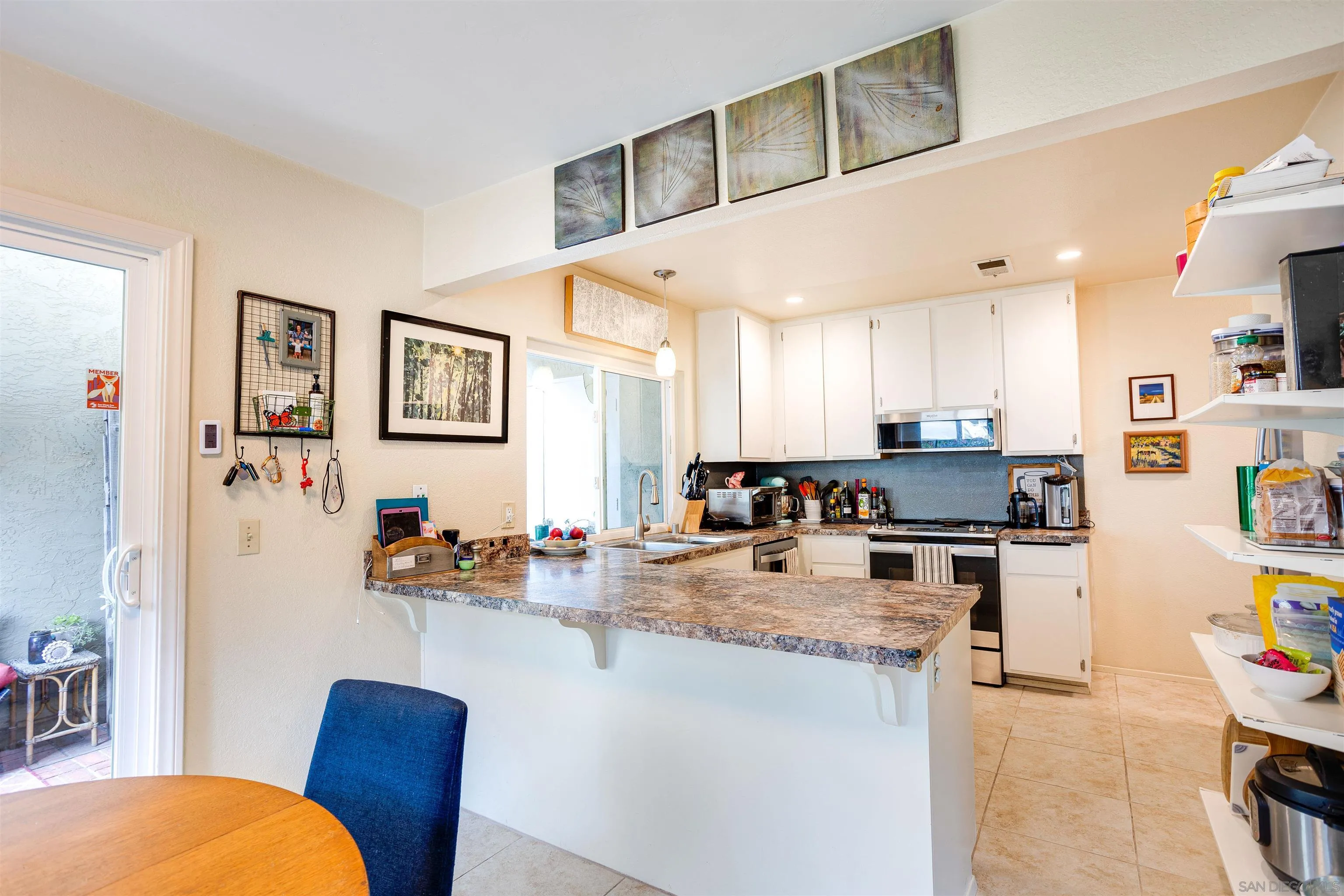 13657 Comuna Drive Poway, CA 92064 - Photo 7 of 36 a kitchen with stainless steel appliances granite countertop a sink and cabinets