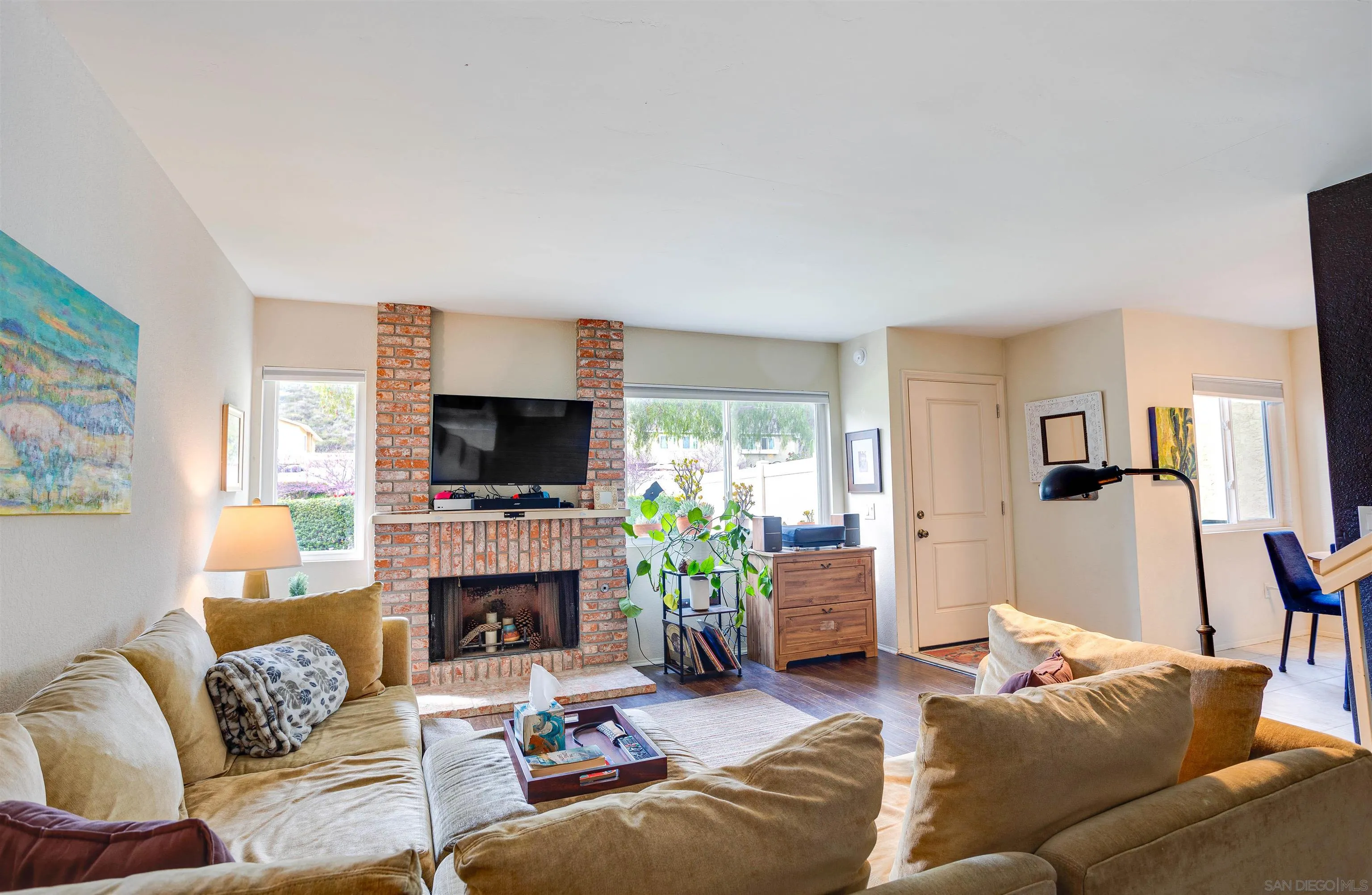 13657 Comuna Drive Poway, CA 92064 - Photo 9 of 36 a living room with furniture a flat screen tv and a fireplace
