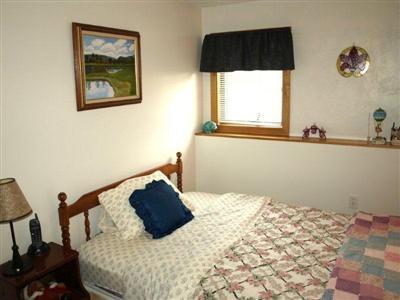 114 Shore Road Truro, MA 02666 - Photo 23 of 30 a bedroom with a bed and two windows