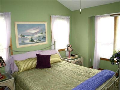 114 Shore Road Truro, MA 02666 - Photo 25 of 30 a bedroom with a bed and wooden floor