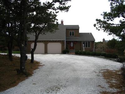 114 Shore Road Truro, MA 02666 - Photo 4 of 30 a front view of a house with a yard and garage