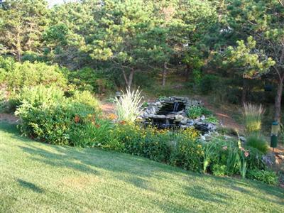 114 Shore Road Truro, MA 02666 - Photo 6 of 30 a backyard of a house with lots of green space and lake view