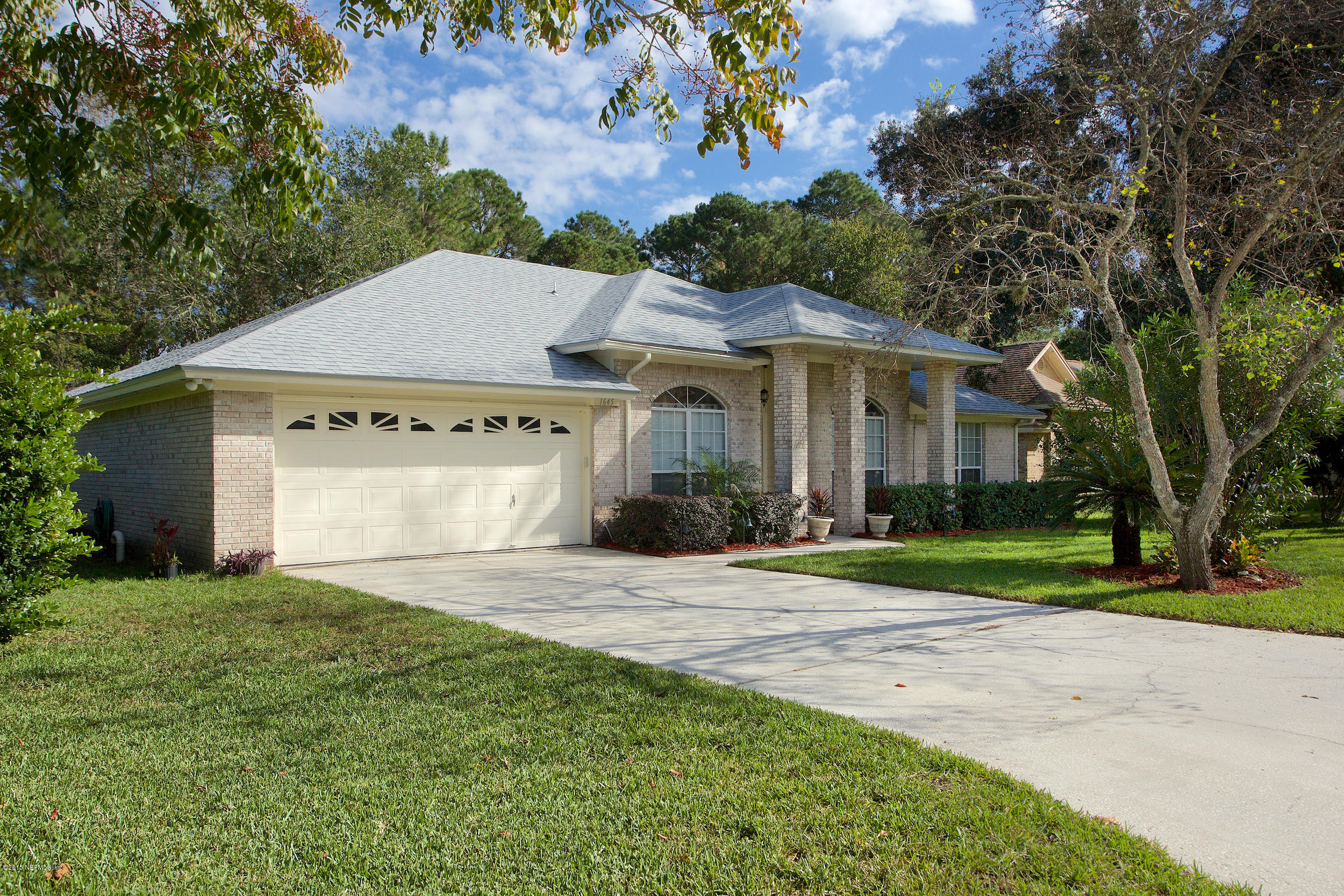 1645 Rusty Rail Road Jacksonville, FL 32225 - Photo 2 of 30 a front view of a house with a yard and trees