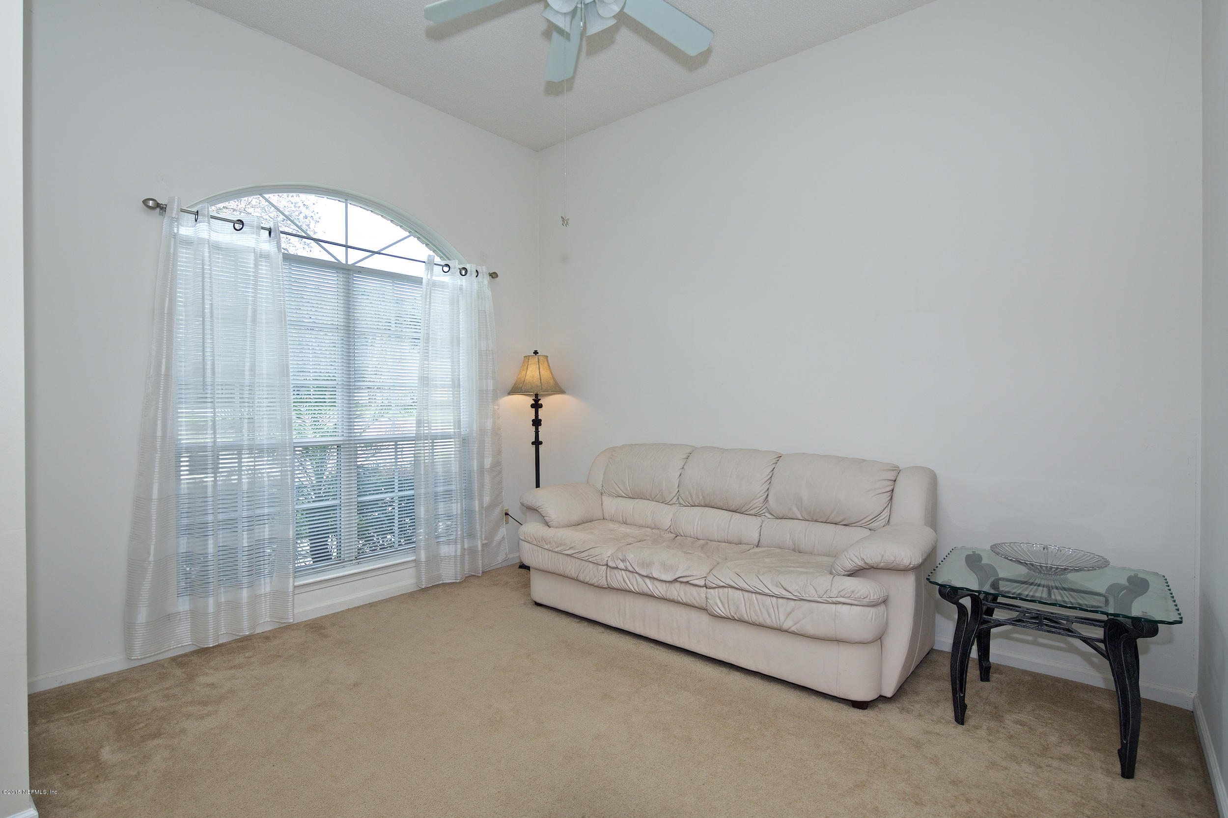 1645 Rusty Rail Road Jacksonville, FL 32225 - Photo 9 of 30 a living room with furniture and a chandelier