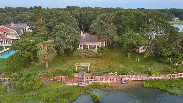 an aerial view of residential houses with outdoor space and river