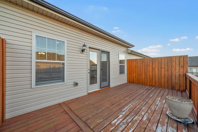 a view of backyard with deck and wooden floor