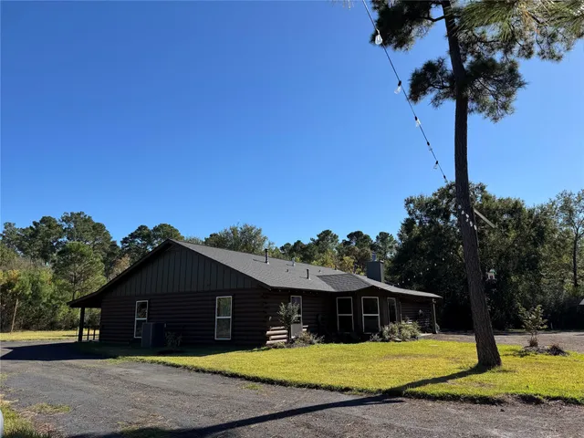 a view of a hallway with entryway and chandelier