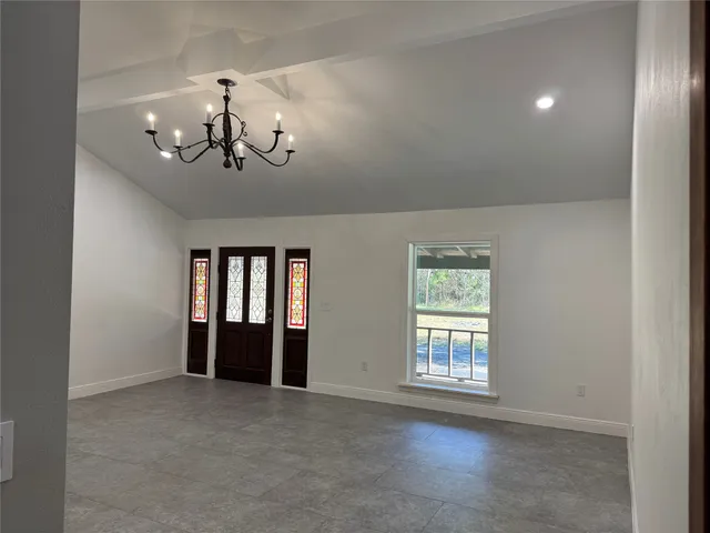 a view of a dining room with furniture wooden floor and chandelier