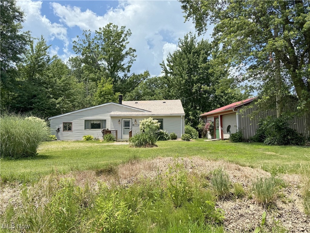 8756 Cook Road Salem, OH 44460 - Photo 1 of 50 Back of property with a lawn, an outdoor structure, and a detached garage