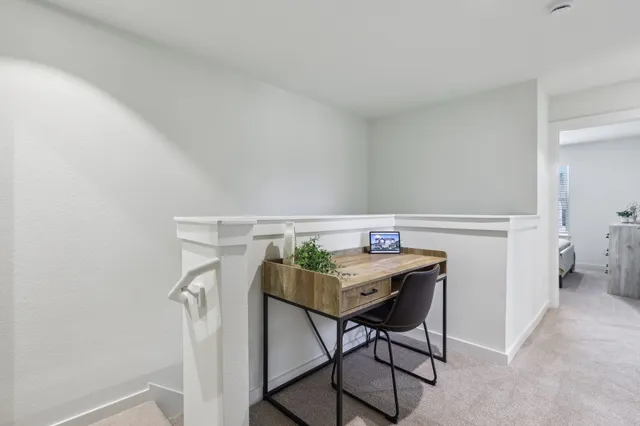 a view of a workspace with furniture