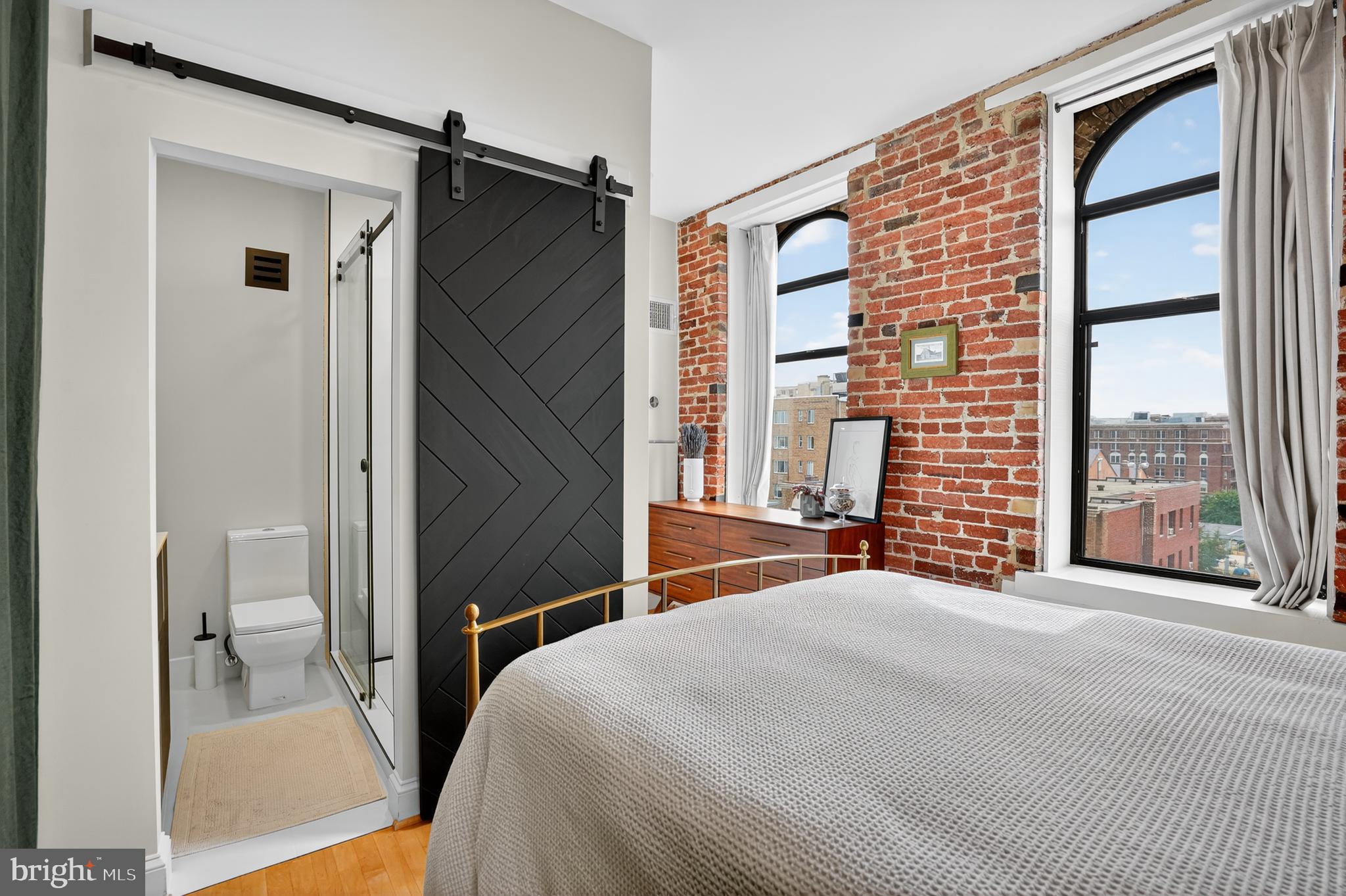 1615 Q Street Northwest, Unit 601 Washington, DC 20009 - Photo 11 of 21 a bedroom with a bed and a large window
