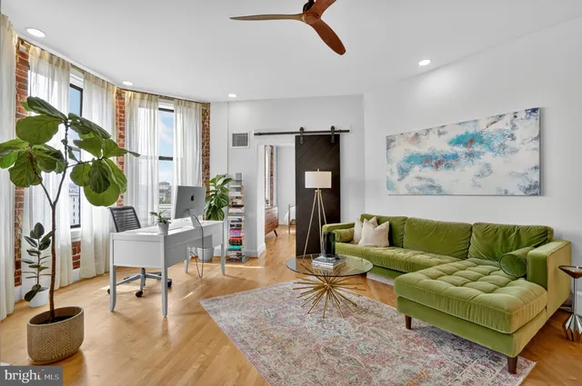 a living room with furniture and a rug