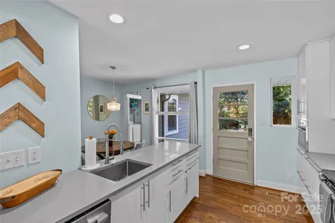 a kitchen with stainless steel appliances a stove a sink a counter space and cabinets