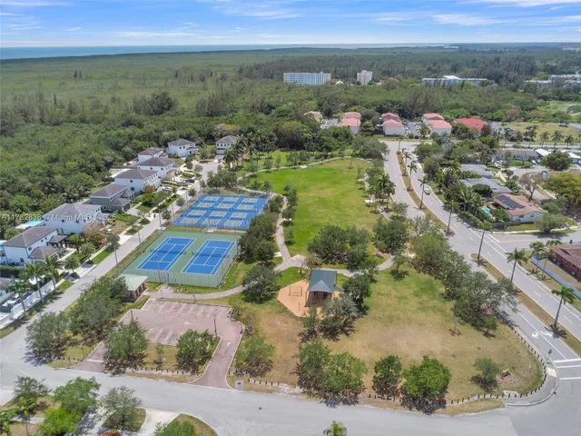 an aerial view of residential houses with outdoor space and river