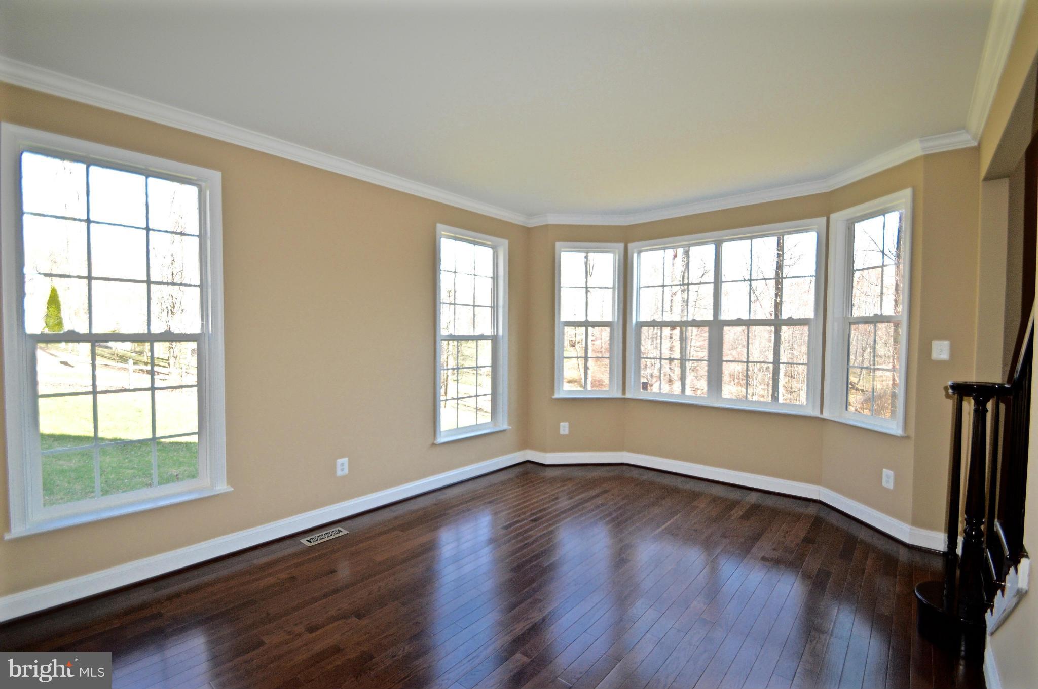 6659 South Clifton Road Frederick, MD 21703 - Photo 7 of 30 a view of an empty room with wooden floor and a window