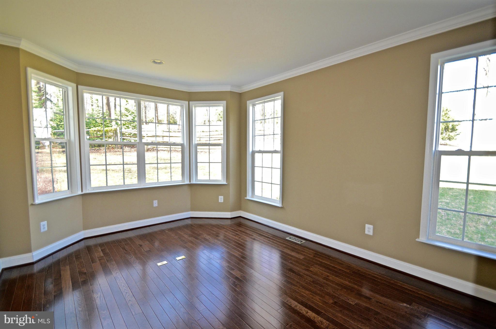6659 South Clifton Road Frederick, MD 21703 - Photo 8 of 30 a view of room with window and wooden floor
