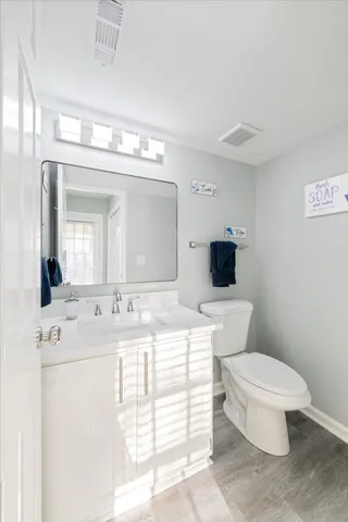 a bathroom with a toilet a sink and a mirror