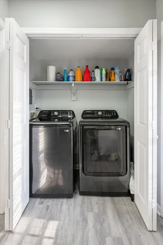 a bathroom with a sink a toilet a mirror a vanity and shower