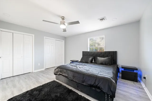 a bathroom with a sink a toilet a mirror and shower