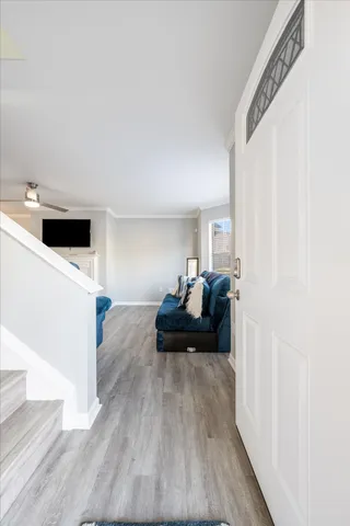 a living room with furniture and a wooden floor