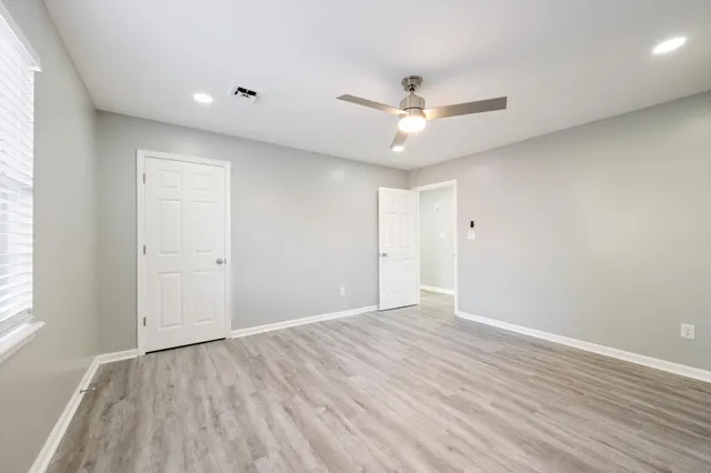 a balcony with wooden floor and fence