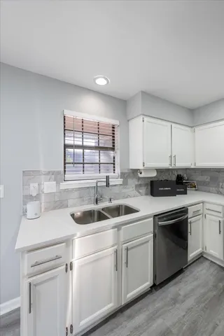 a kitchen with a sink and cabinets