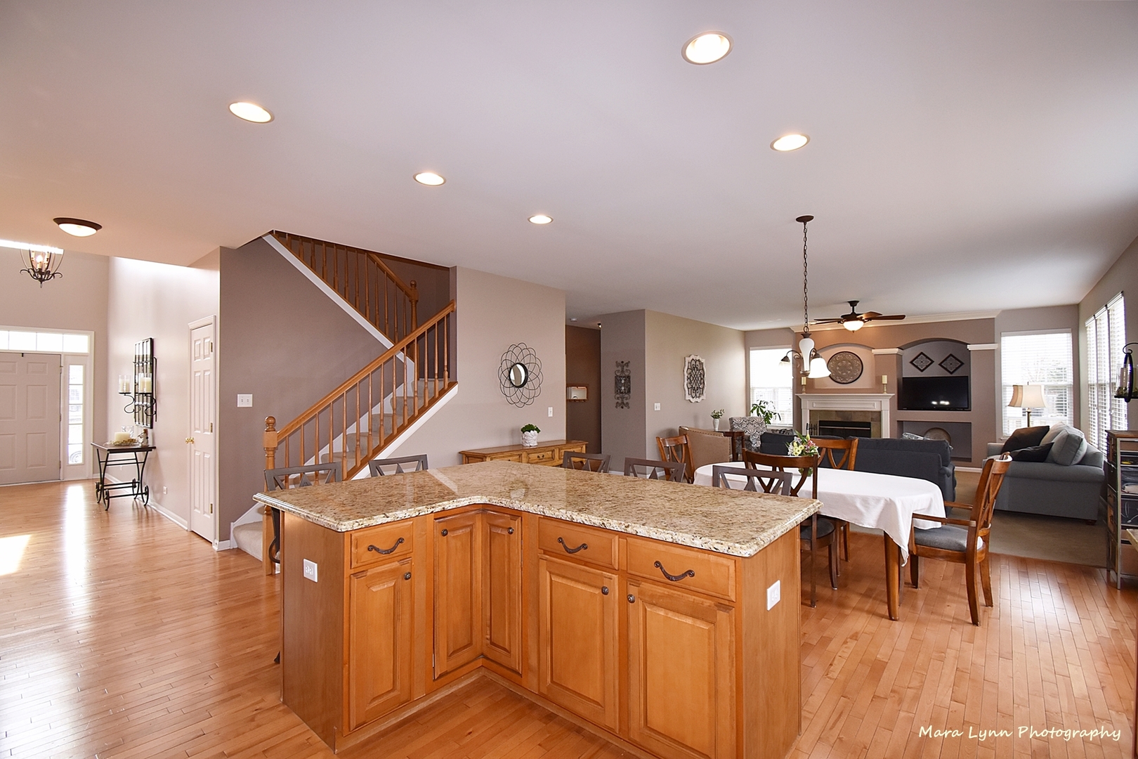 294 Sonora Drive Elgin, IL 60124 - Photo 15 of 40 a view of a kitchen with kitchen island stainless steel appliances refrigerator stove dining table and chairs