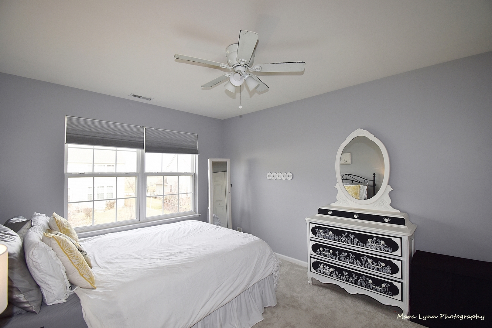294 Sonora Drive Elgin, IL 60124 - Photo 28 of 40 a bedroom with a bed a chandelier and a window