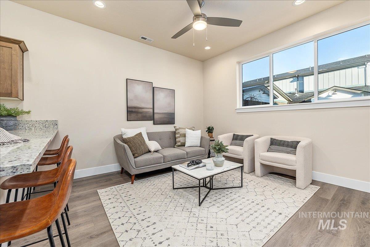1445 North Bluffs Ridge Lane Boise, ID 83704 - Photo 22 of 47 Living area with recessed lighting, light wood finished floors, and ceiling fan