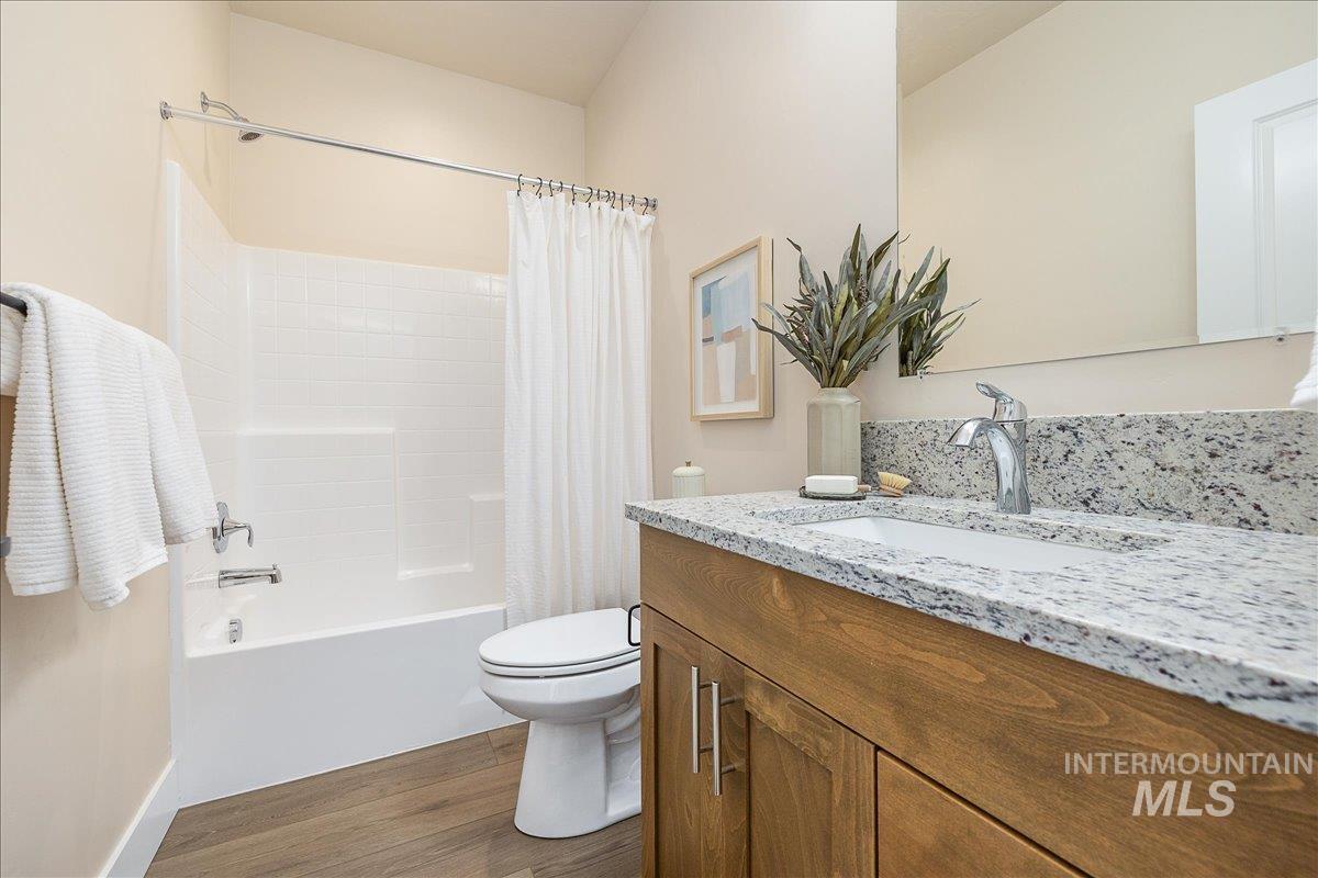 1445 North Bluffs Ridge Lane Boise, ID 83704 - Photo 45 of 47 Full bathroom with dark wood-style floors, shower / bath combo, and vanity