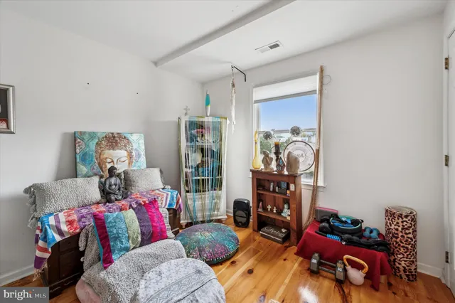 a living room with furniture and a book shelf