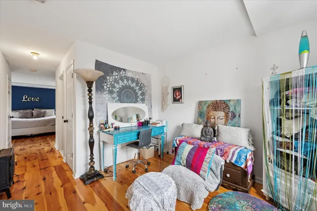 a bedroom with a bed and wooden floor