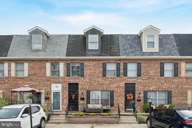 a front view of a residential apartment building with a yard