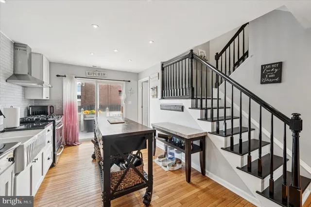 a view of a kitchen with workspace and wooden floor