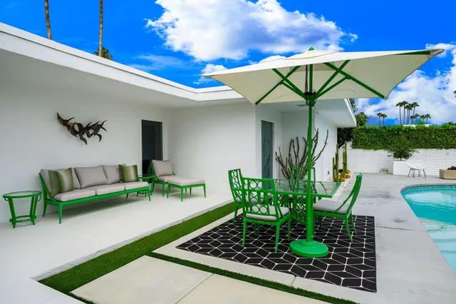 a dining room with furniture and a floor to ceiling window