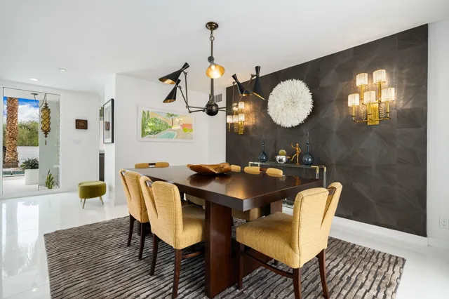 a kitchen with a stove a refrigerator and chandelier
